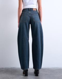 Model wearing Barrel mid rise jean in deep blue