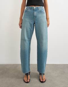 Model wearing Barrel mid rise jean in green cast