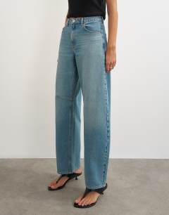 Model wearing Barrel mid rise jean in green cast