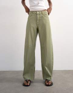 Model wearing Barrel mid rise jean in green stripe