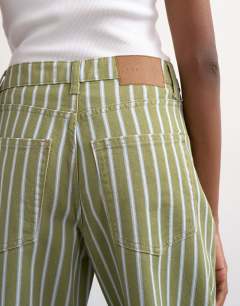 Model wearing Barrel mid rise jean in green stripe