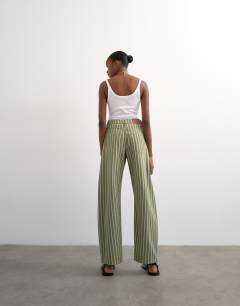 Model wearing Barrel mid rise jean in green stripe