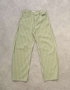 Model wearing Barrel mid rise jean in green stripe