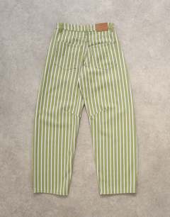 Model wearing Barrel mid rise jean in green stripe