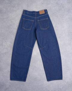 Model wearing Barrel mid rise jean in indigo rinse