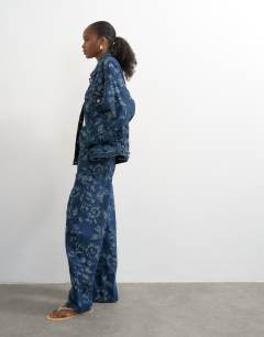 Model wearing Barrel mid rise jean in jacquard floral