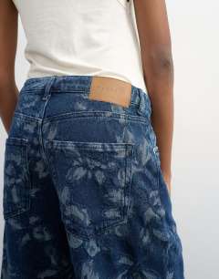 Model wearing Barrel mid rise jean in jacquard floral
