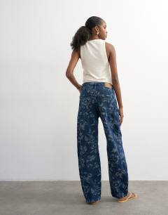 Model wearing Barrel mid rise jean in jacquard floral