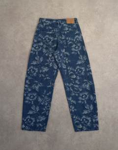 Model wearing Barrel mid rise jean in jacquard floral