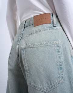 Model wearing Barrel mid rise jean in mint green