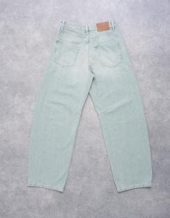 Model wearing Barrel mid rise jean in mint green