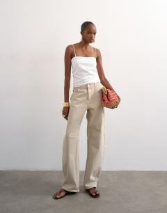 Model wearing Barrel mid rise jean in oat