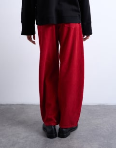 Model wearing Barrel mid rise jean in red cord