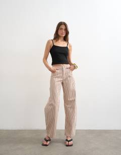 Model wearing Barrel mid rise jean in red stripe