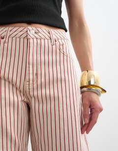 Model wearing Barrel mid rise jean in red stripe