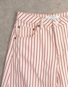 Model wearing Barrel mid rise jean in red stripe