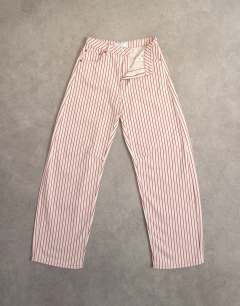 Model wearing Barrel mid rise jean in red stripe