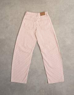 Model wearing Barrel mid rise jean in red stripe