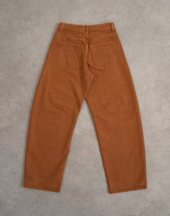 Model wearing Barrel mid rise jean in toffee