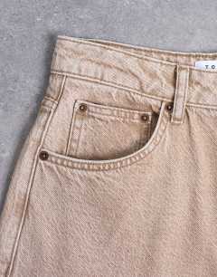 Model wearing Barrel mid rise jean in washed beige