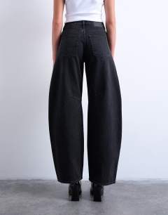 Model wearing Barrel mid rise jean in washed black