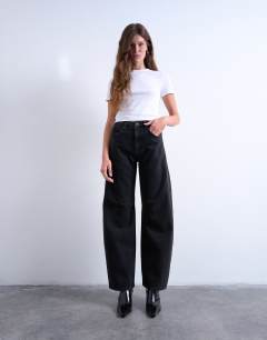 Model wearing Barrel mid rise jean in washed black 