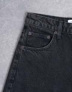 Model wearing Barrel mid rise jean in washed black 