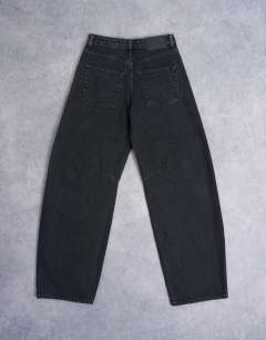 Model wearing Barrel mid rise jean in washed black 