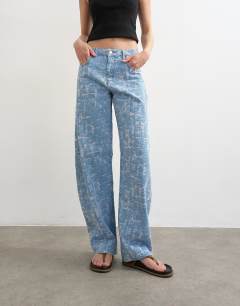 Model wearing Barrel mid rise jean ultra-distressed bleach