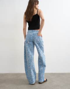 Model wearing Barrel mid rise jean ultra-distressed bleach
