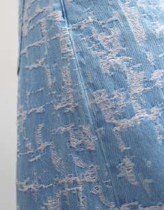 Model wearing Barrel mid rise jean ultra-distressed bleach