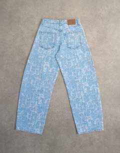 Model wearing Barrel mid rise jean ultra-distressed bleach