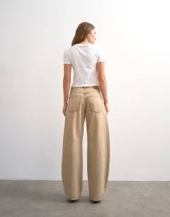 Model wearing Barrel mid rise jeans in washed beige