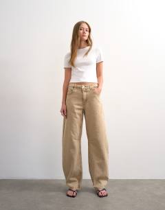 Model wearing Barrel mid rise jeans in washed beige