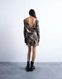Model wearing Batwing backless mini dress in black blurred check