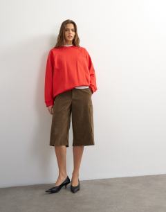 Model wearing Batwing skater sweat in red