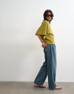 Model wearing Batwing t-shirt in green