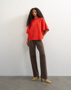 Model wearing Batwing t-shirt in red