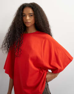 Model wearing Batwing t-shirt in red