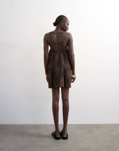 Model wearing Beaded strap trapeze mini dress with 3D cording in brown