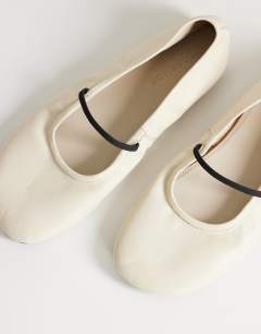 Model wearing Bella leather round toe ballet flat in off white