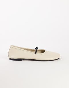 Model wearing Bella leather round toe ballet flat in off white