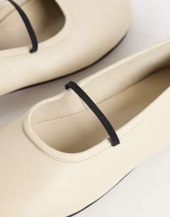Model wearing Bella leather round toe ballet flat in off white