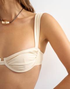 Model wearing Bella underwire bikini top in off white