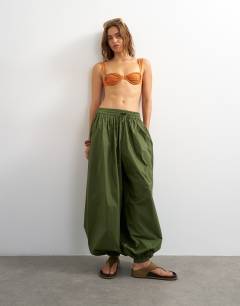 Model wearing Bella underwire bikini top in rust 