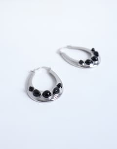 Model wearing Belle hoop earrings with black semi-precious stones in silver