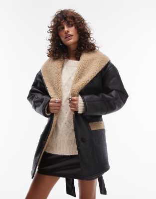 belted faux leather shearling jacket in black and cream