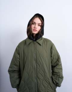 Model wearing Belted long liner jacket in green 