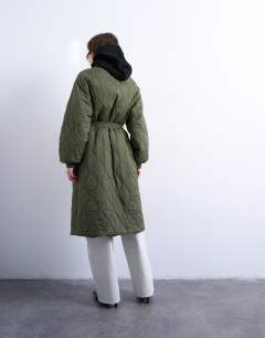 Model wearing Belted long liner jacket in green 