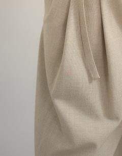 Model wearing Belted pleated cropped wide leg trouser in beige
